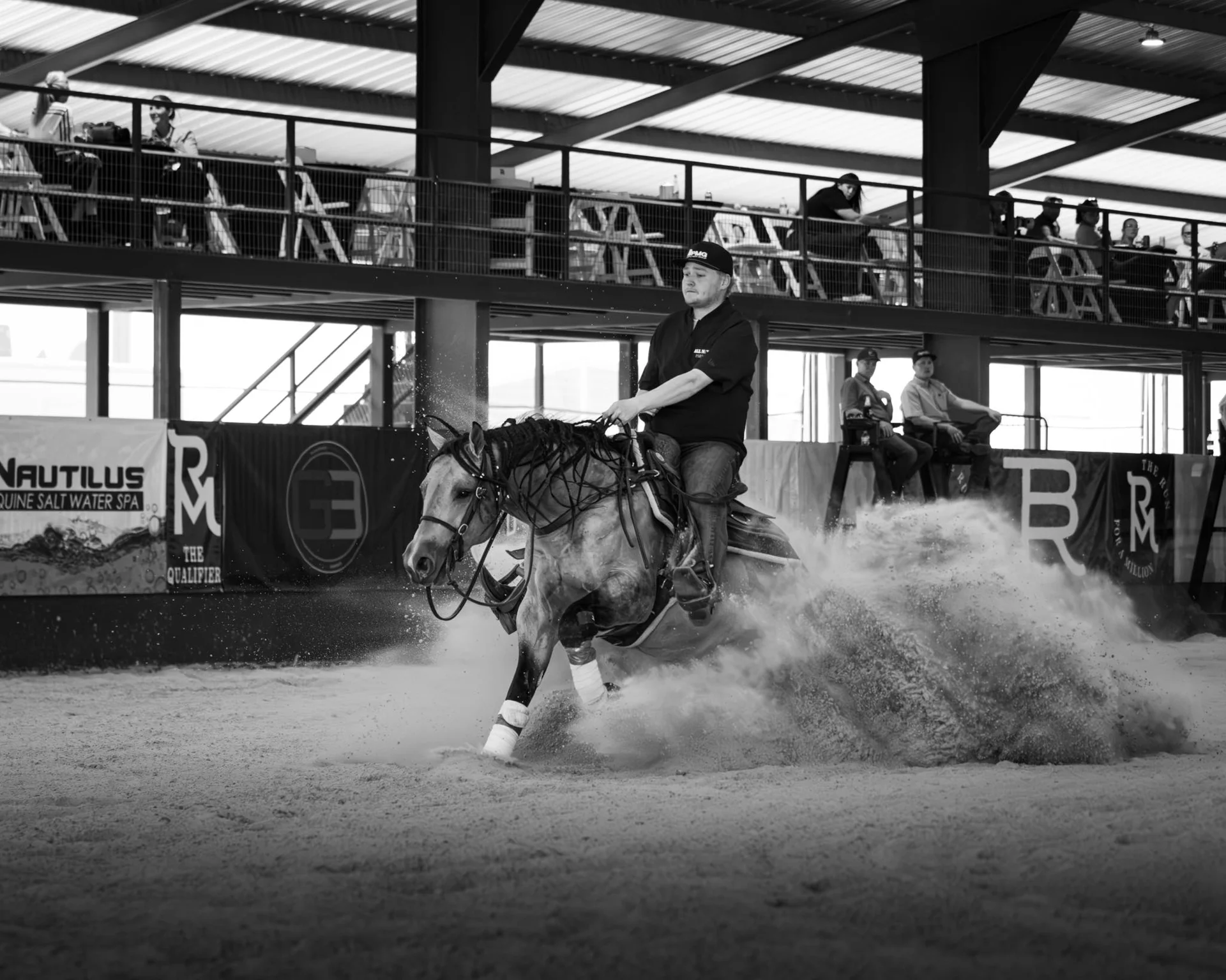 black and white photo of a rider riding outta yur league coming to a stop