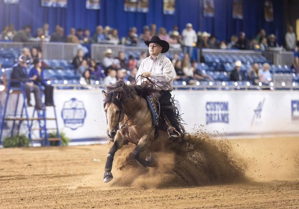rider running with outta yur league in an arena